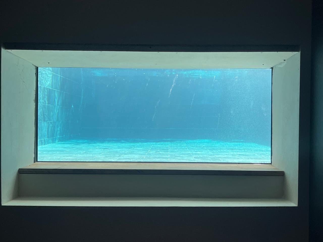 Porthole from the wine cellar into the swimming pool