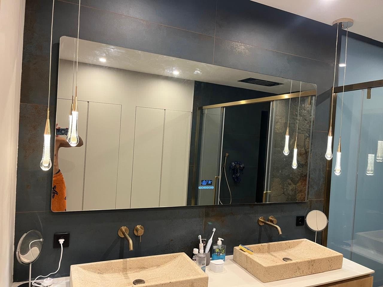 Double travertine basins, LED mirror and brass pendant lights