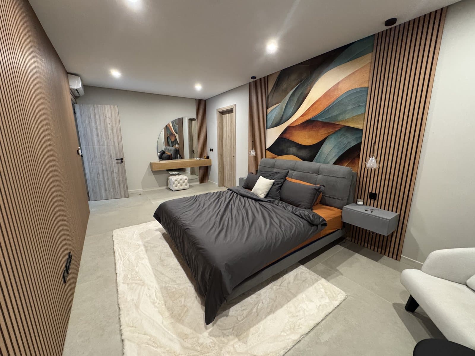 Master suite with king bed, abstract artwork and oak slat wall